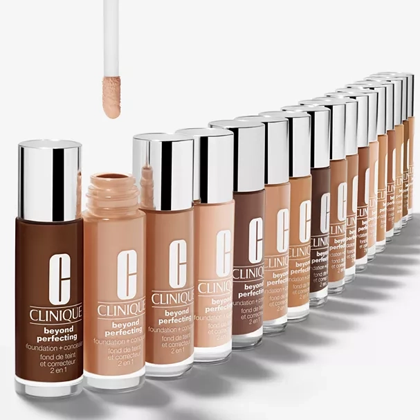 A variety of Clinique Beyond Perfecting foundation + concealer bottles in multiple shades, arranged in a line.