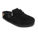 Black suede clog with a buckle strap and shearling lining, featuring a cork and rubber sole.