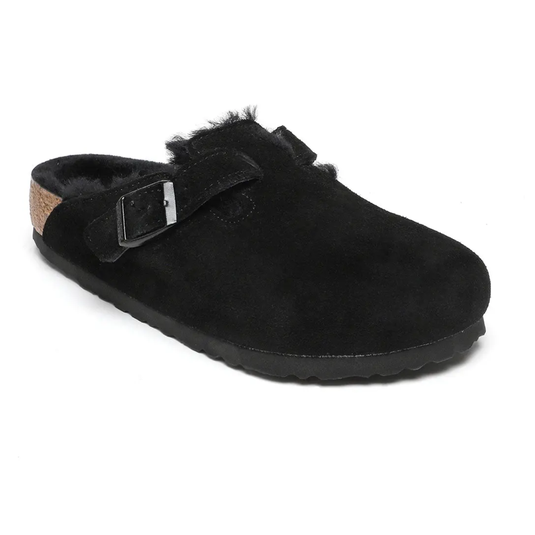 Black suede clog with a buckle strap and shearling lining, featuring a cork and rubber sole.