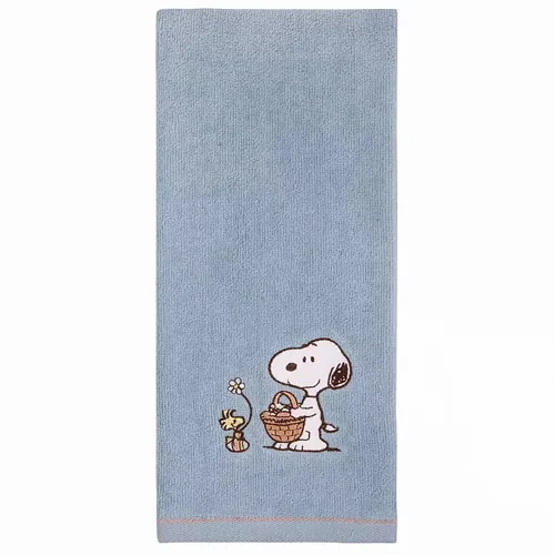 A light blue towel featuring Snoopy and Woodstock with a basket and a flower.