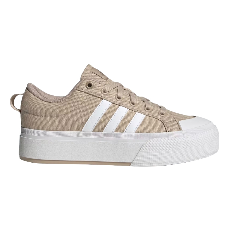 Tan canvas sneaker with a white rubber sole and white stripes on the side.