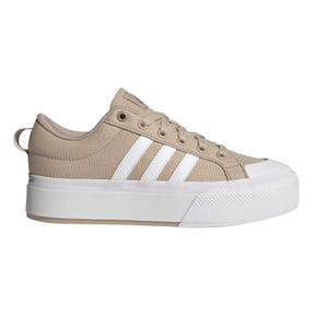 Tan canvas sneaker with a white rubber sole and white stripes on the side.