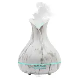 A marble-patterned essential oil diffuser, emitting mist, with timer settings for 1H, 3H, 6H, and continuous operation, and features a \“Light\“ and \“Mist\“ button.