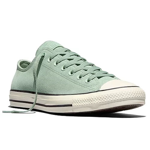 A light green low-top sneaker with white rubber toe cap and soles, featuring a lace-up design and black stripe detailing.