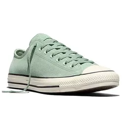 A light green low-top sneaker with white rubber toe cap and soles, featuring a lace-up design and black stripe detailing.