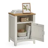 A white and wood accent cabinet with an open shelf and a lower cabinet. It holds a framed picture, books, a vintage radio, and a woven basket.