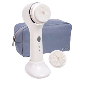 Conair Sonic Facial Brush Kit includes a white handheld facial cleansing brush with adjustable speed settings, two interchangeable brush heads, and a compact zippered storage pouch.