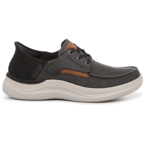 A casual slip-on shoe with a gray fabric upper, white cushioned sole, and black and brown accents. Designed for comfort with lace detailing and \“Sketchers Slip-Ins\“ branding.