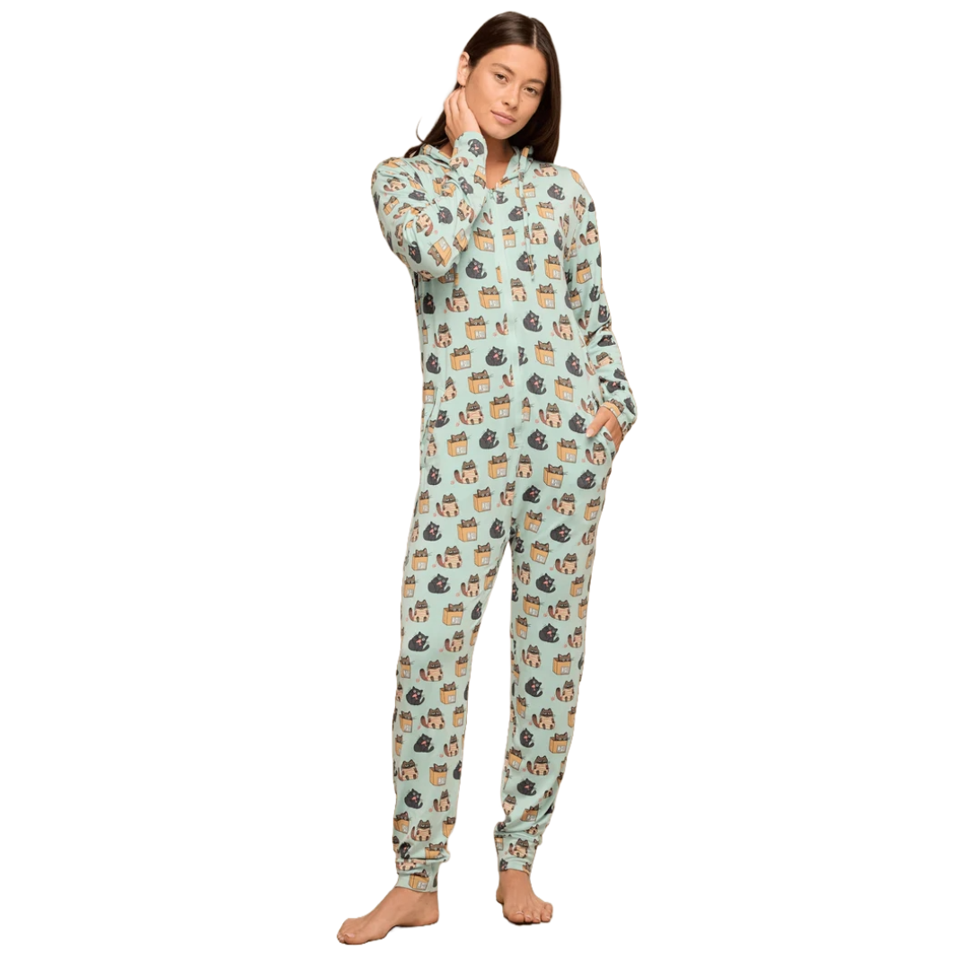 A person is wearing a light blue onesie featuring a playful cat pattern. The onesie is long-sleeved, has a front zipper, and includes two pockets, with a snug fit at the ankles.