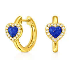 A pair of gold hoop earrings featuring heart-shaped blue stones, surrounded by a halo of small clear gemstones.