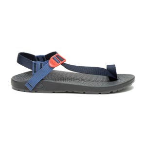 A navy blue sandal with adjustable straps, featuring a red buckle and a textured black sole.