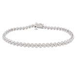 A white gold tennis bracelet featuring a series of round, bezel-set diamonds with a box clasp closure.