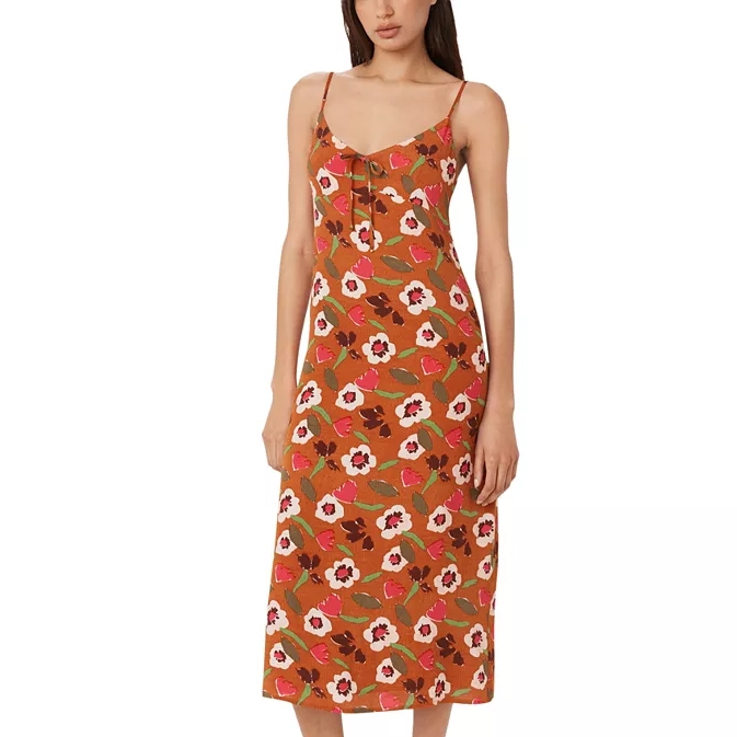 A floral print slip dress with thin straps and a mid-calf hemline.