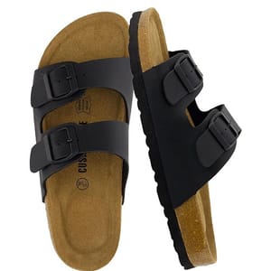 A pair of black double-strap sandals with adjustable buckles and a cork footbed designed for comfort and support.