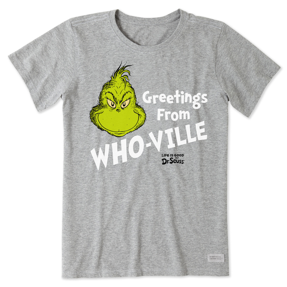 A gray women's t-shirt featuring the Grinch from Dr. Seuss with the text \“Greetings From WHO-VILLE\“ and \“Life is Good\“ printed in white. The Grinch's head is prominently displayed in green, adding contrast to the design.