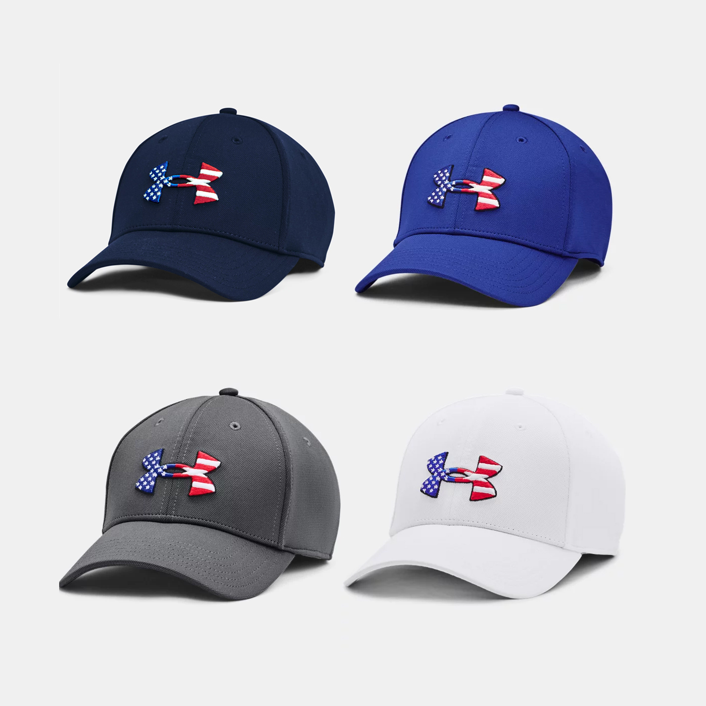 Four baseball caps in navy, royal blue, gray, and white, each with an American flag-themed ribbon embroidered on the front.