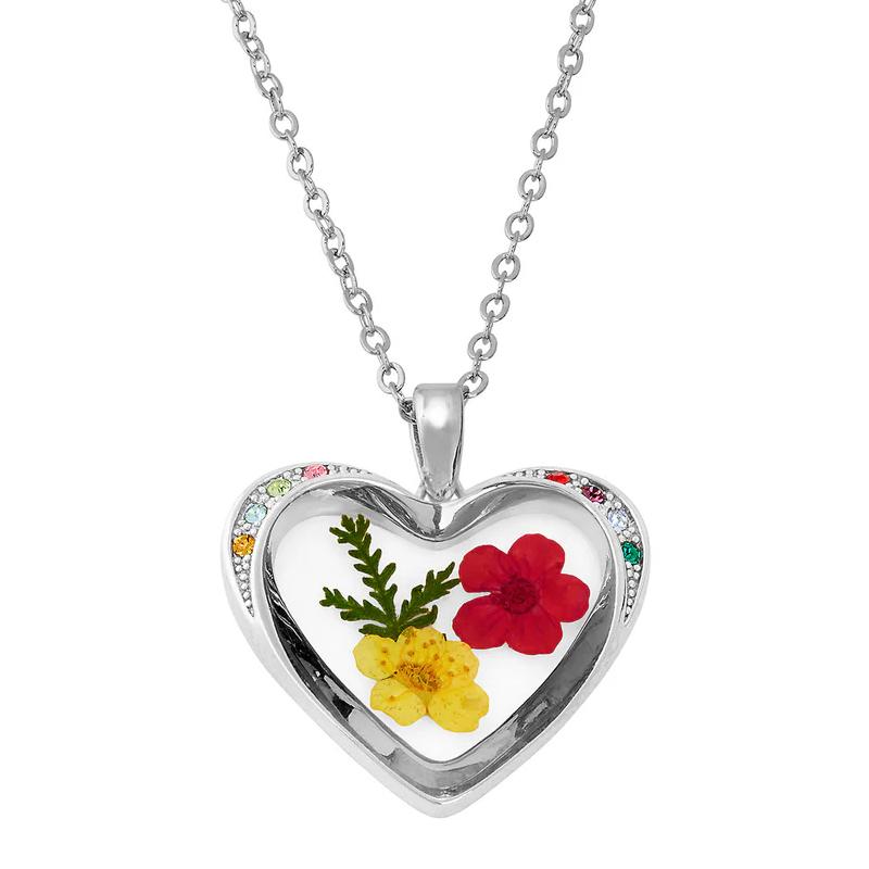 Heart-shaped pendant necklace with dried red and yellow flowers inside, featuring a silver chain and multicolored gemstones along the border.