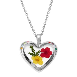 Heart-shaped pendant necklace with dried red and yellow flowers inside, featuring a silver chain and multicolored gemstones along the border.