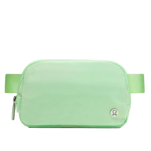 A light green Lululemon belt bag with a simple design, featuring a zipper closure and the brand's logo on the front.