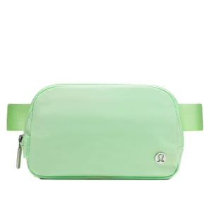 A light green Lululemon belt bag with a simple design, featuring a zipper closure and the brand's logo on the front.