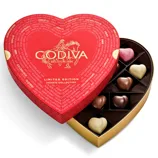 Heart-shaped box of Godiva chocolates with various flavors, featuring a red lid with gold lettering and a \“Limited Edition Hearts Collection\“ label.