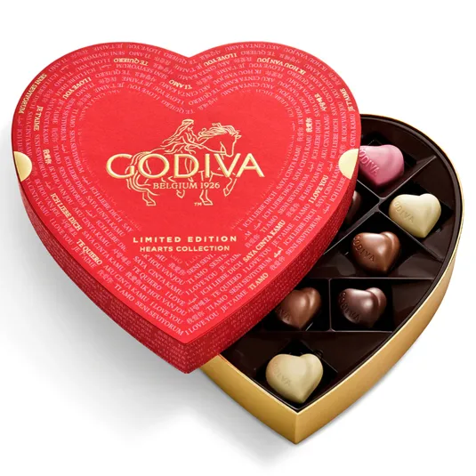 Heart-shaped box of Godiva chocolates with various flavors, featuring a red lid with gold lettering and a \“Limited Edition Hearts Collection\“ label.
