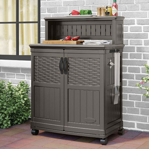 Outdoor storage cabinet with wheels, featuring two doors and a towel holder, topped with kitchen items like a cutting board and condiments.