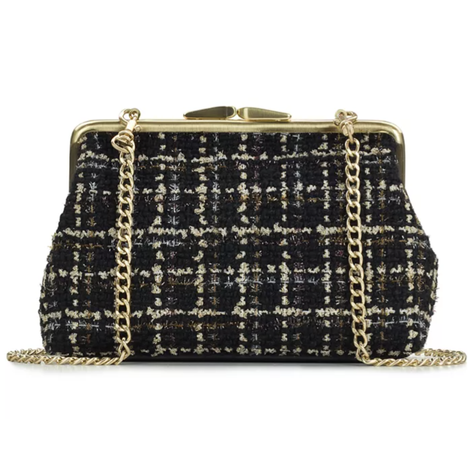 A tweed handbag with a black, white, and gold checkered pattern, featuring a gold chain strap and a metal clasp closure.