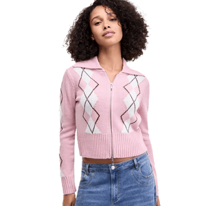 A woman wears a pink argyle zip-up sweater and blue jeans. The sweater features a pointed collar and ribbed cuffs.