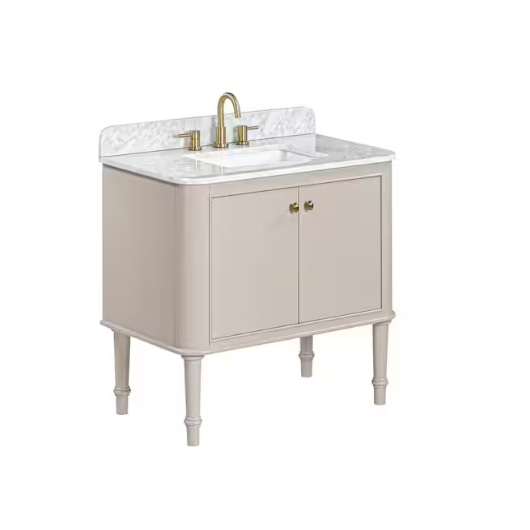 A beige bathroom vanity with a marble countertop and backsplash features a built-in sink, gold faucet, and dual door storage. The unit stands on four slender legs.