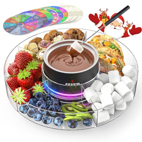 A fondue set featuring a central pot with melted chocolate surrounded by strawberries, blueberries, kiwi, cookies, pistachios, marshmallows, and tacos on a transparent tray with festive decorations. A set of colorful game spinners is included.