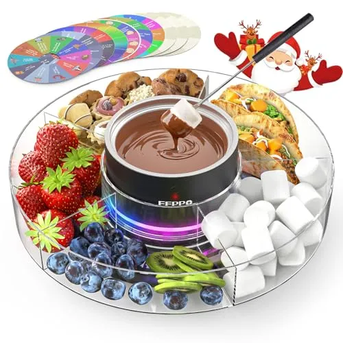 A fondue set featuring a central pot with melted chocolate surrounded by strawberries, blueberries, kiwi, cookies, pistachios, marshmallows, and tacos on a transparent tray with festive decorations. A set of colorful game spinners is included.