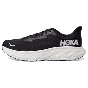 A black and white running shoe with a thick, cushioned sole, featuring the HOKA logo on the side. The design is streamlined with breathable material.