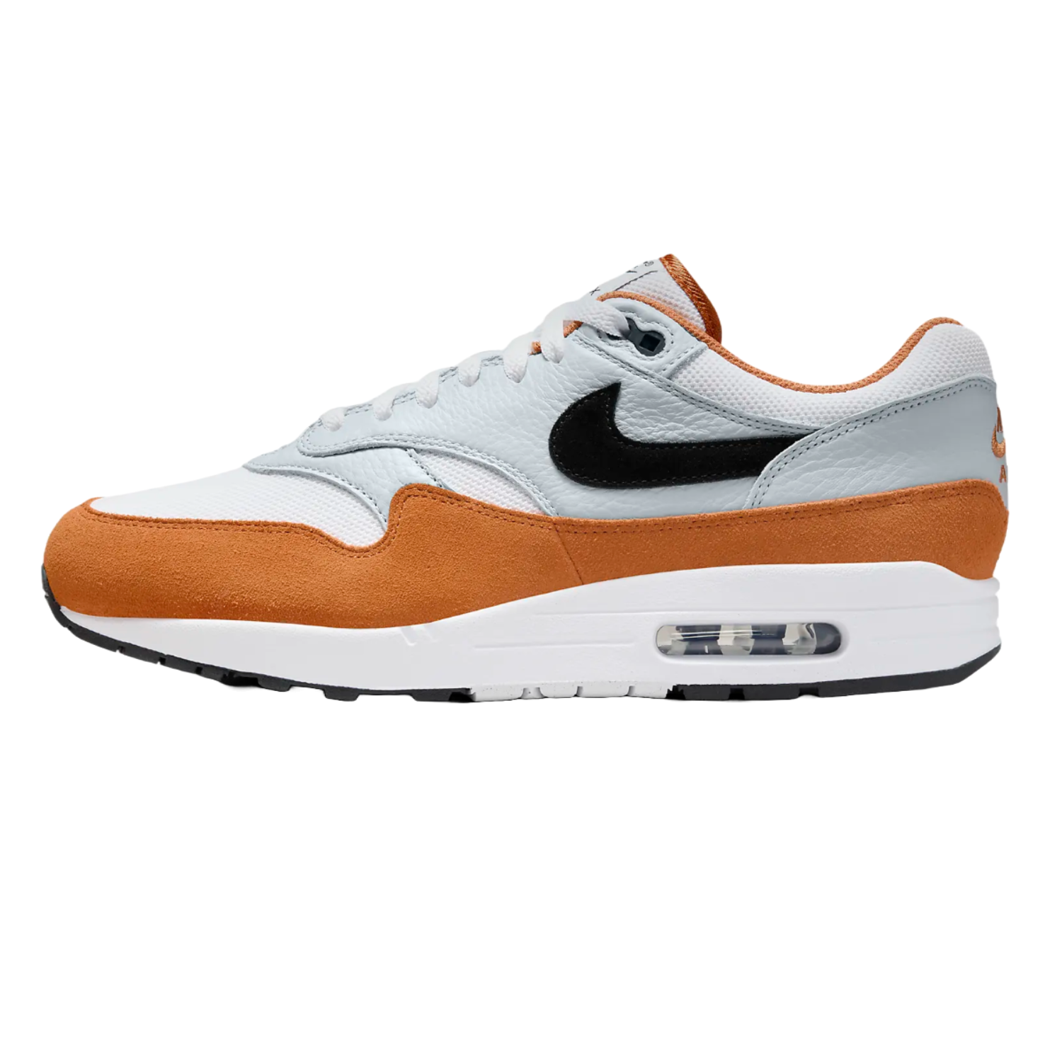 The Nike Men's Air Max 1 Shoes feature a white and orange suede with light grey leather upper, a black Swoosh, and visible Air cushioning in a white midsole, providing a classic and sporty look.