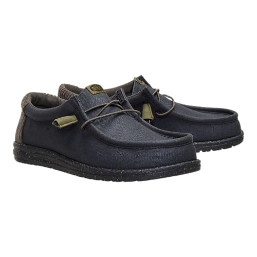 Casual navy blue slip-on shoes with a textured finish and elastic lace detailing, featuring a low-profile sole.