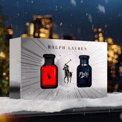 Ralph Lauren fragrance gift set with two bottles: one in red and one in blue, featuring the Polo logo with a snowflake-like design between them.