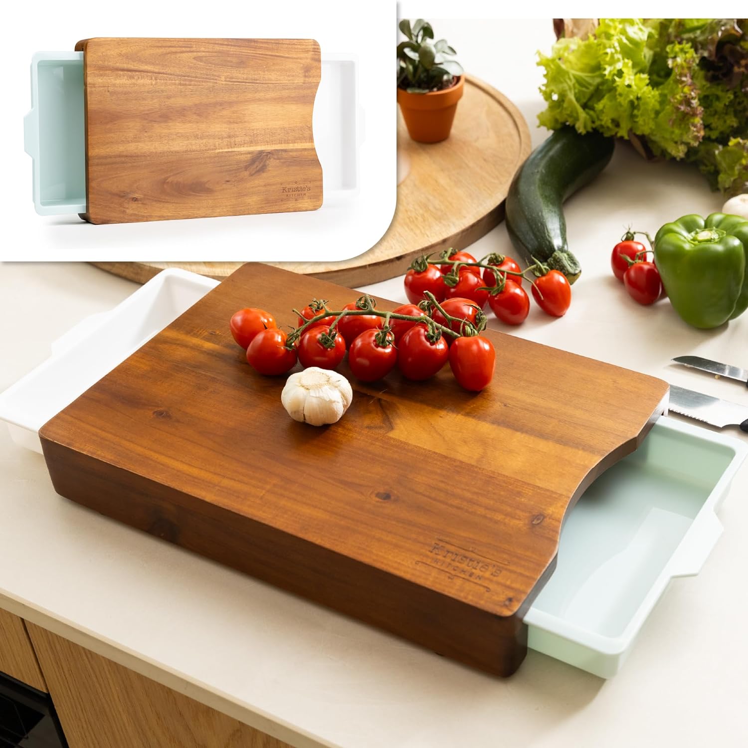 Set of three cutting boards, one with a slide-out tray, surrounded by vegetables on a kitchen counter.