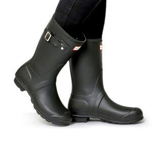Black mid-calf waterproof boots with a side buckle and a red and white logo on the front top edge.