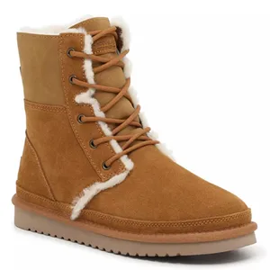 Tan suede winter boot with faux fur lining, lace-up design, and flat sole.