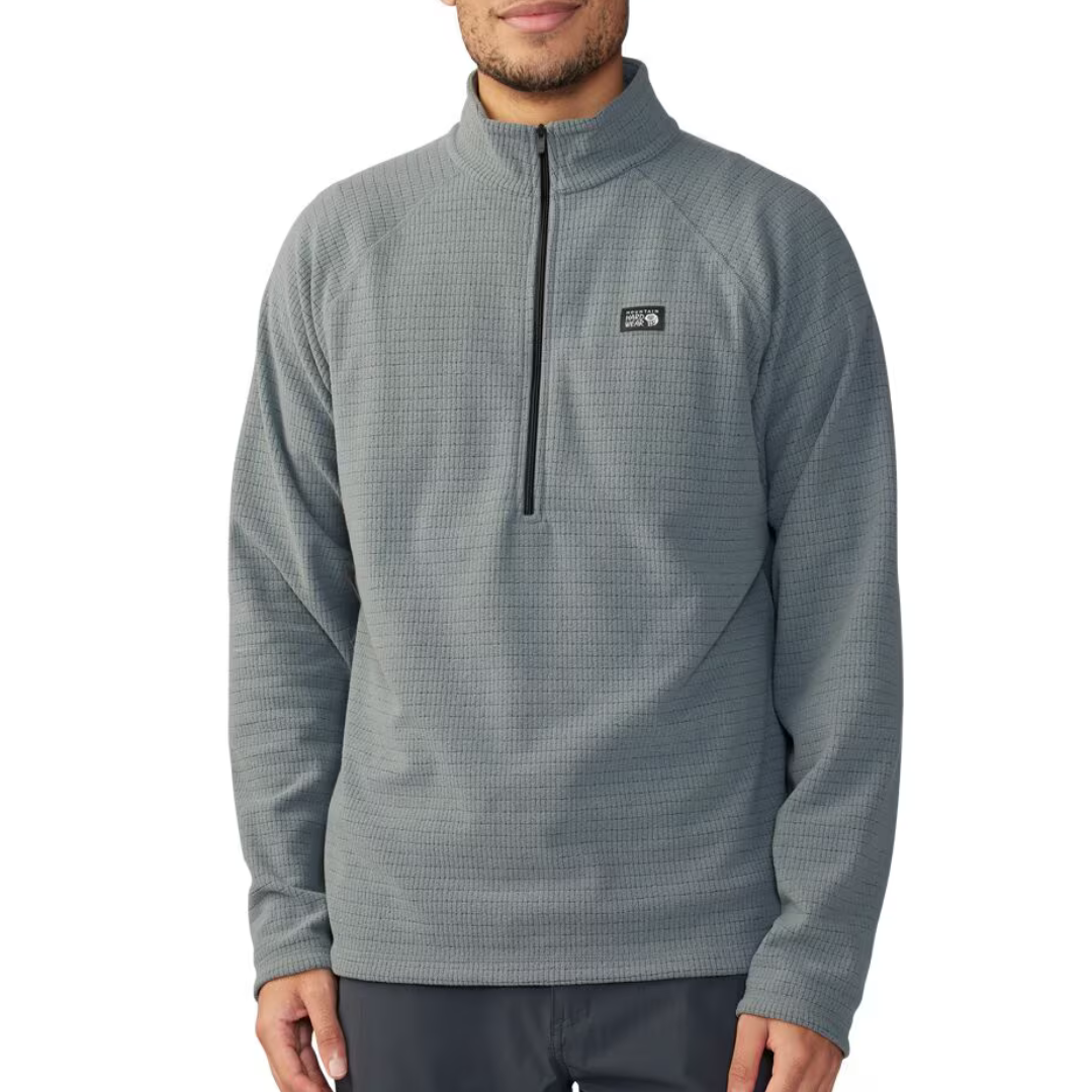 A person wearing a gray quarter-zip fleece pullover with a small logo on the left chest.