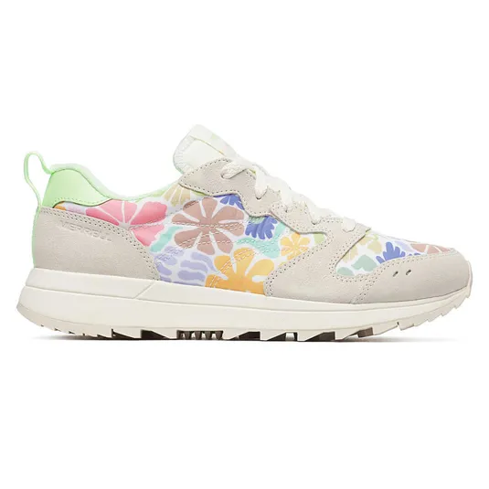A colorful sneaker features floral patterns with suede accents, a light green heel tab, and white laces.