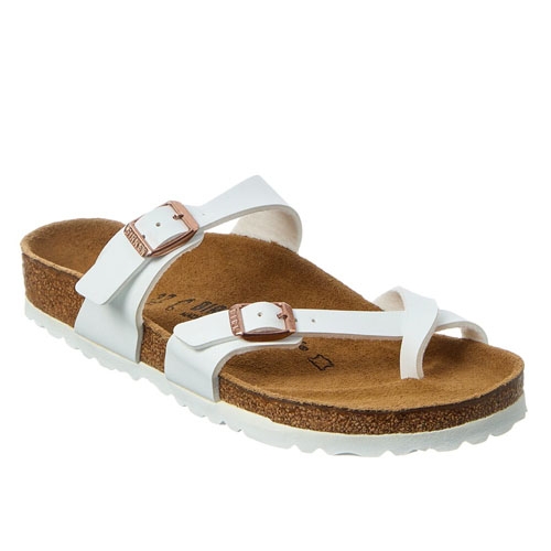 A white sandal with a cork footbed, featuring a toe loop and two adjustable straps with metal buckles.