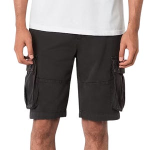 A person is wearing black cargo shorts with large side pockets and a white T-shirt.