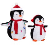 Two festive penguin decorations, each wearing a red scarf and Santa hat, with one adorned in colorful Christmas lights.