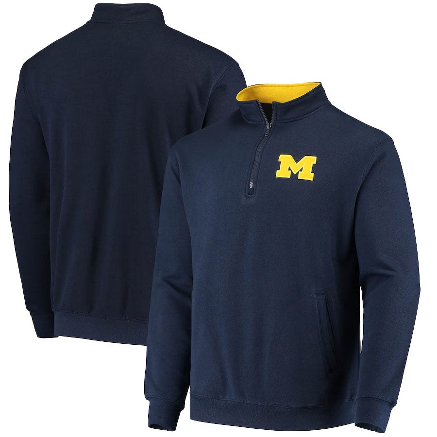 A navy blue quarter-zip pullover with a yellow \“M\“ logo on the chest, featuring ribbed cuffs and a contrasting yellow inner collar.