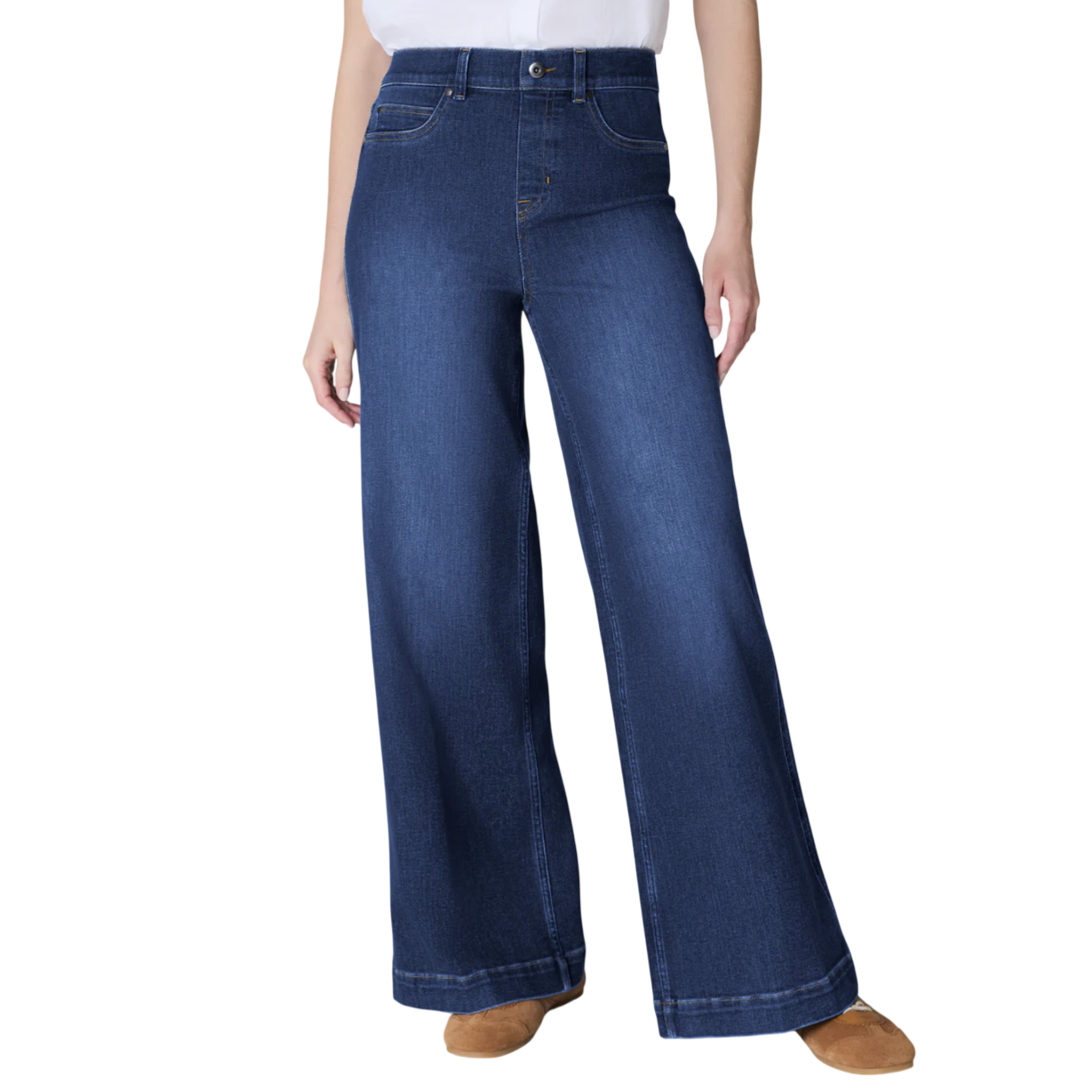 Wide-leg denim jeans with a high waist, contrasted with a white tucked-in shirt and brown shoes.