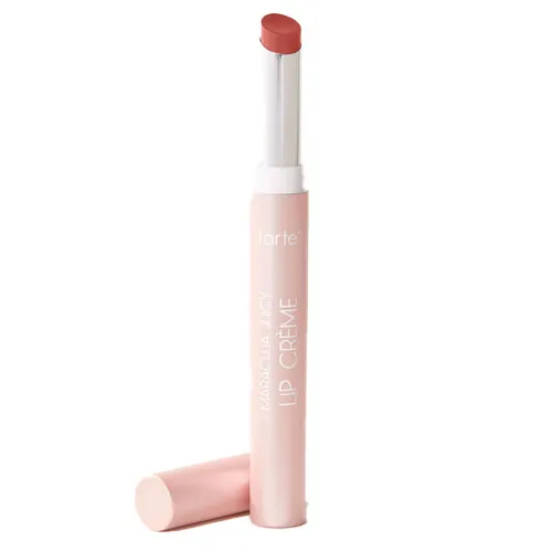 A Tarte Maracuja Juicy Lip Crème lipstick in a light pink tube with the cap off, revealing a rose-colored product.
