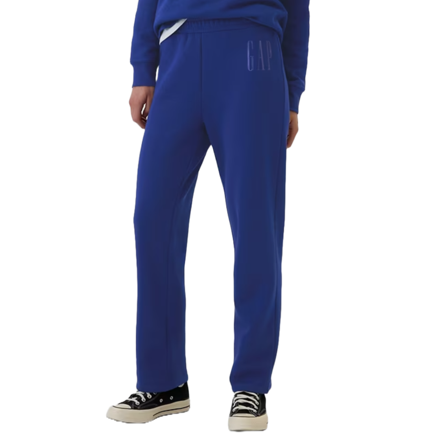 Blue Gap Factory bootcut sweatpants featuring an elastic waistband, subtle \“GAP\“ logo on the side, and a loose fit. Paired with black sneakers for a casual look.