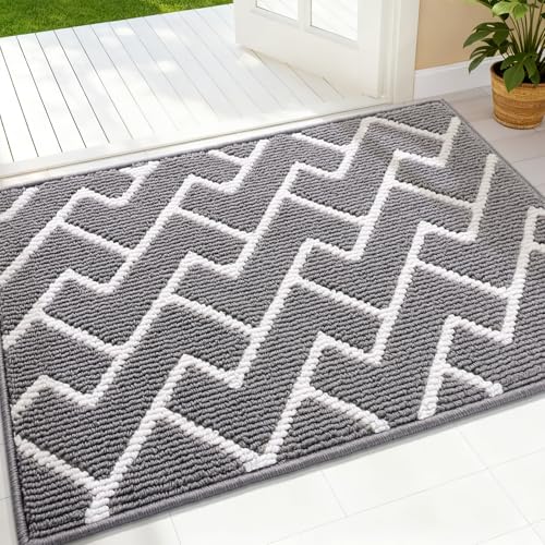 A gray and white chevron-patterned rug is placed near a doorway, with its textured design complementing a bright, open indoor space.