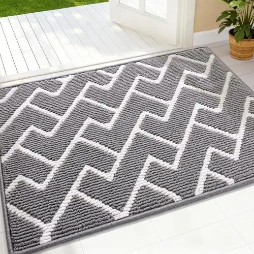 A gray and white chevron-patterned rug is placed near a doorway, with its textured design complementing a bright, open indoor space.